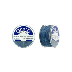 May include: A spool of blue beading thread labeled "One G Beads Thread 50yards TOHO CO.,LTD. 300denier" and "Made in Japan".