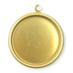 May include: A gold-toned metal pendant with a round, flat surface and a loop at the top for hanging.