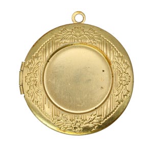 May include: A round, gold-colored locket with a hinged opening. The locket features a floral and leaf design around the edges and a textured pattern. It has a small loop at the top for a chain. The locket is empty inside.