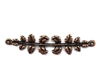 May include: A copper-colored metal leaf garland with two loops on either end for attaching to a project. The garland features a series of leaves with a detailed design.