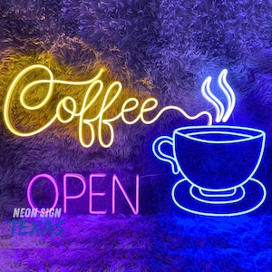 May include: Neon sign with the words "Coffee" in yellow and "Open" in pink, with a blue neon cup of coffee with steam rising from it.
