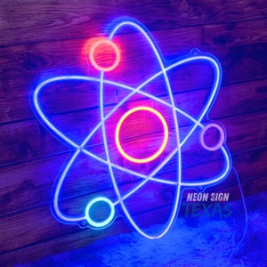 May include: A neon sign in the shape of an atom, with a blue outline and colorful circles. The sign has the text "NEON SIGN TEXAS" in white. The sign is mounted on a wooden surface.