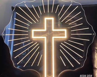 May include: A white neon cross with a sunburst design behind it. The cross is illuminated and the background is clear acrylic. The sign says "NEON SIGN TEXAS" in the bottom right corner.