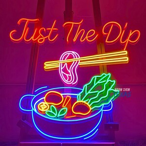 May include: Neon sign with the text "Just The Dip" in red, a bowl of colorful food with chopsticks holding a piece of meat above it, and the text "Neon Sign" in white.