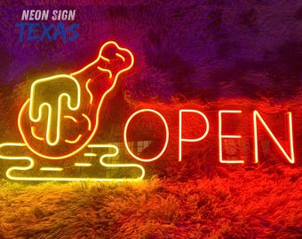 May include: A neon sign with the word "OPEN" in bright white letters. The sign also features a neon image of a chicken leg and a hand, with the words "NEON SIGN TEXAS" in the upper left corner. The sign is illuminated with yellow and orange neon lights.