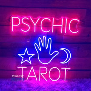 May include: Neon sign with the words "PSYCHIC TAROT" in pink and white. The sign also features a blue hand, a star, and a crescent moon.