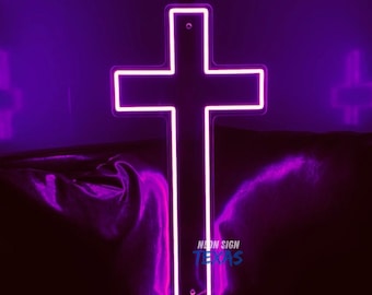 May include: A purple neon cross sign with the text "NEON SIGN TEXAS" at the bottom.