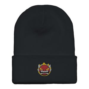 May include: Black beanie with a red and yellow embroidered angry face on the front.