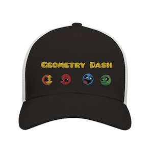 May include: Black and white trucker hat with a black brim and a white mesh back. The hat has the words "Geometry Dash" embroidered in gold on the front, along with four colorful icons.