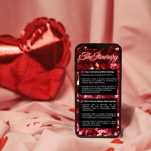 May include: A smartphone screen displaying a romantic getaway itinerary with a pink and red heart background. The itinerary includes a hot air balloon ride, wine tasting, and spa treatments. The text on the screen reads "The Itinerary" and lists activities for two days.