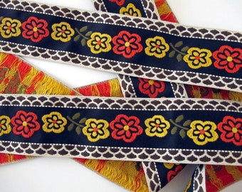 BAVARIAN DAISIES Jacquard trim. Orange, yellow, olive, ivory, brown on black. Sold by the yard. 2 inch wide. 2017-A