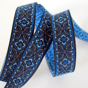 BRONZE AGE narrow Jacquard trim in blue and light blue on black. Sold by the yard. 5/8 inch wide. 582-A(2)  Geometric trim