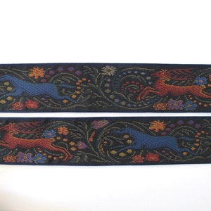 Medieval tapestry wide Jacquard trim with a brown stag and a blue wolf in a floral garden on a black background