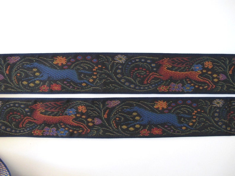 Medieval tapestry wide Jacquard trim with a brown stag and a blue wolf in a floral garden on a black background