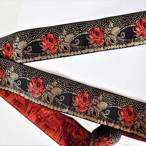 deep red roses on a black jacquard trim with gold details in pointille