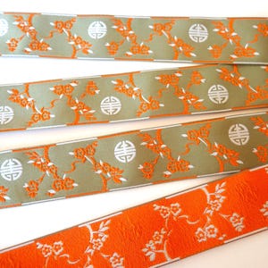 CHINESE BLOSSOMS Jacquard trim, SAKURA blossoms orange, ivory, on beige. Sold by the yard. 1 1/2 inch wide.  696-A, cherry blossoms