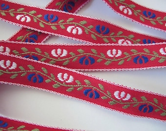 BAVARIAN TRILLIUM Jacquard trim White, blue, green on red. White edges. Sold by the yard. 5/8 inch wide. 2050-A Bavarian dress trim