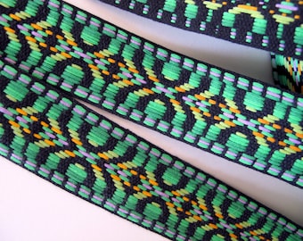 Geometric FOLK TRIM REVERSIBLE Jacquard trim in neon green, purple, lime on black. Sold by the yard. 1 1/4 inch wide. 479-D. Guitar strap