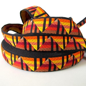 GIZA Pyramids Jacquard trim in orange,yellow,burgundy,red, tan on black. Sold by the yard. 1 1/4 inch wide. 2094(2)-B Sunset on the pyramids