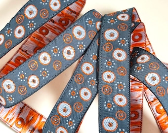 Gustav KLIMT ribbon Jacquard in light blue, silky bronze on deep slate grey. 3/4 inch wide. Sold by the yard. 5086-A floating bubbles