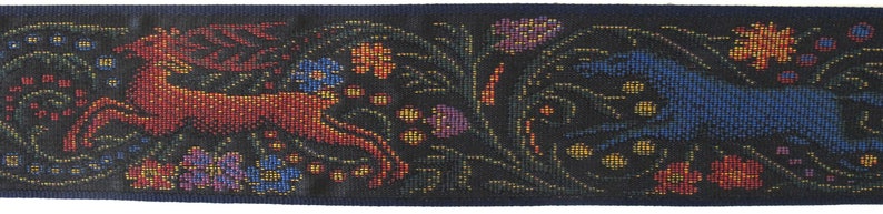 Medieval tapestry wide Jacquard trim with a brown stag and a blue wolf in a floral garden on a black background