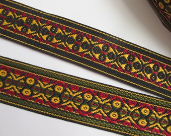 FOUR WHEELS reversible Jacquard strap in red, yellow, green on black. Sold by the yard. 1 3/8 inch wide. 975-A. A geometric trim