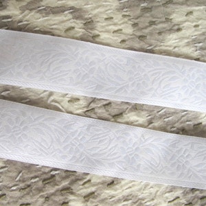 white on white floral jacquard embroidered trim with white flowers and leaves on a white background