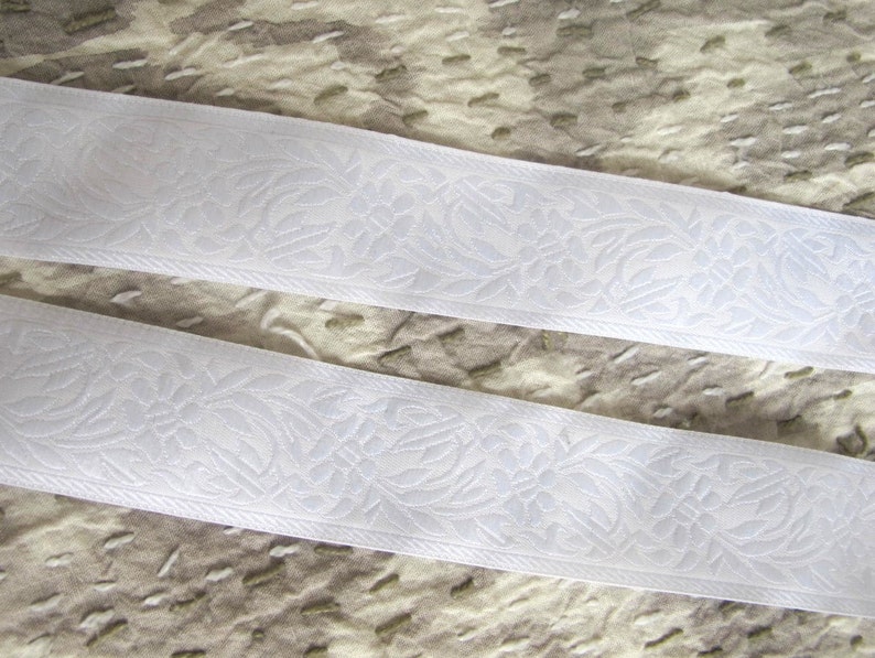 white on white floral jacquard embroidered trim with white flowers and leaves on a white background