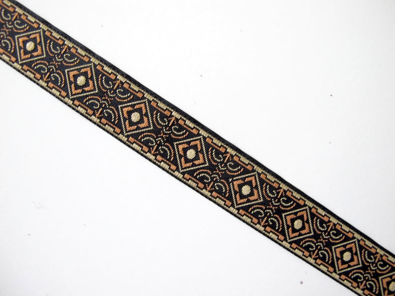 BRONZE AGE Narrow Jacquard Trim in Brown and Tan on Black. Sold by the ...