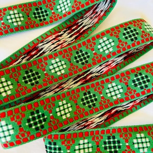 Scandinavian geometric Jacquard trim, red, black, white, on green. Sold by the yard. 1 1/4 inches wide. V05-A. Traditional Swedish Bavarian