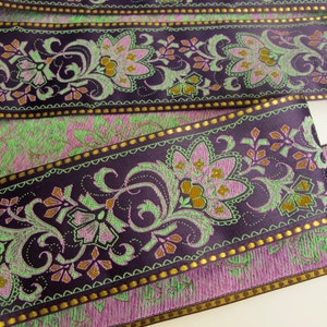 wide purple textile jacquard ribbon trim with rich florals in green, mustard yellow, lavender mauve and metallic gold threads, over 2 inches wide