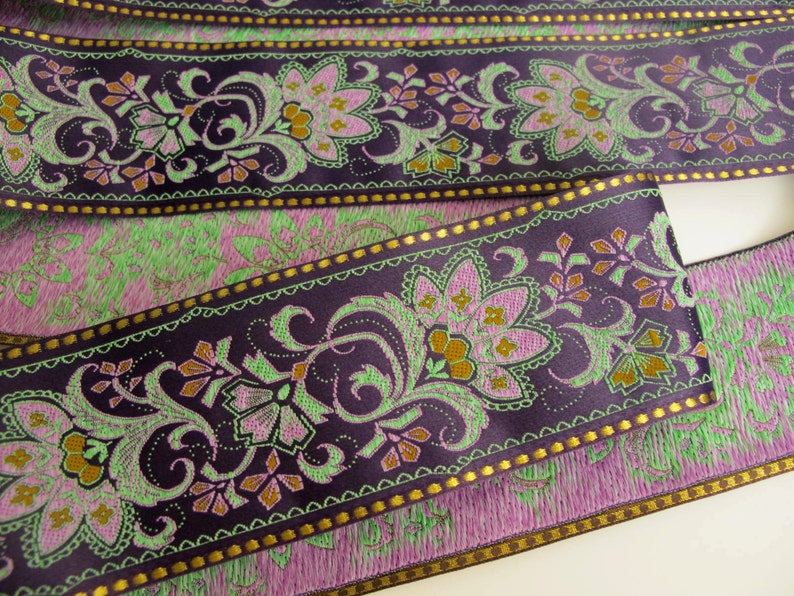 wide purple textile jacquard ribbon trim with rich florals in green, mustard yellow, lavender mauve and metallic gold threads, over 2 inches wide