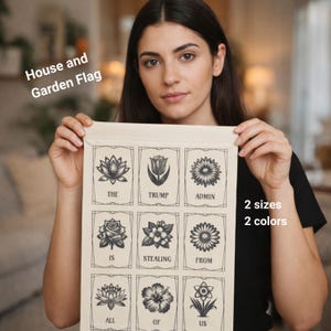 Könnte beinhalten: Eine beige Haus- und Gartenflagge mit floralem Design und dem Text "THE TRUMP ADMIN IS STEALING FROM ALL OF US". Die Flagge ist in 2 Größen und 2 Farben erhältlich.