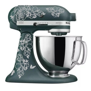 May include: A teal stand mixer with a silver bowl and a white floral design. The mixer has the word "Artisan" printed on the side.