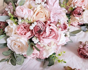 Pode incluir: Uma coleção de flores artificiais em tons de rosa e creme, incluindo rosas, peónias e dálias, dispostas em bouquets e pequenos detalhes florais. A folhagem verde contrasta com a suave paleta de cores. Ideal para casamentos ou decoração de casa.