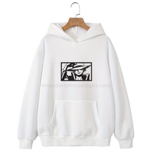 May include: White hoodie with a black and white illustration of a cartoon character wearing a hat. The text "threadartistrydesigns.com" is printed on the bottom of the hoodie.