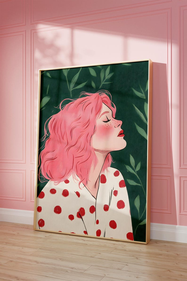 May include: A framed illustration of a person with pink hair and red polka dots on a white shirt. The background is a dark green with leaves.