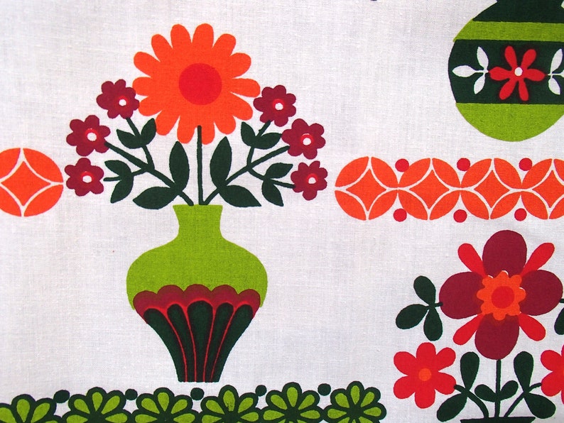 May include: A vintage floral print fabric featuring a green vase with red and green accents, filled with orange and red flowers. The fabric also features a repeating pattern of orange and red circles.