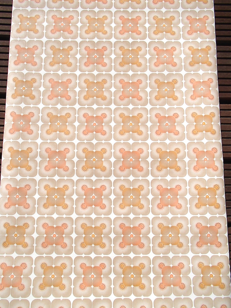 May include: A vintage wallpaper with a repeating pattern of brown and peach squares with a white background.