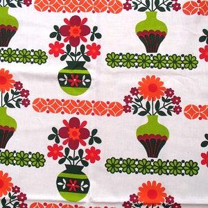 May include: A white fabric with a repeating pattern of green, orange and red flowers in green vases. The flowers have a retro 1970s style.