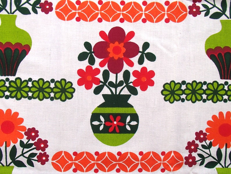 May include: A vintage fabric design featuring a repeating pattern of green, red, orange, and white flowers in vases. The flowers are stylised and have a retro 1970s feel.