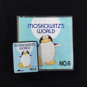 Könnte beinhalten: Eine CD-Hülle und eine kleine quadratische Karte mit dem Text "MOSKOWITZ'S WORLD" und einem Cartoon-Pinguin. Die CD-Hülle hat einen hellblauen Hintergrund mit einem weißen Kreis und dem Text "MOSKOWITZ'S WORLD" in Blau. Die Karte hat das gleiche Design.