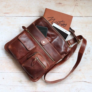 brown leather crossbody bag with front pockets and long adjustable shoulder strap