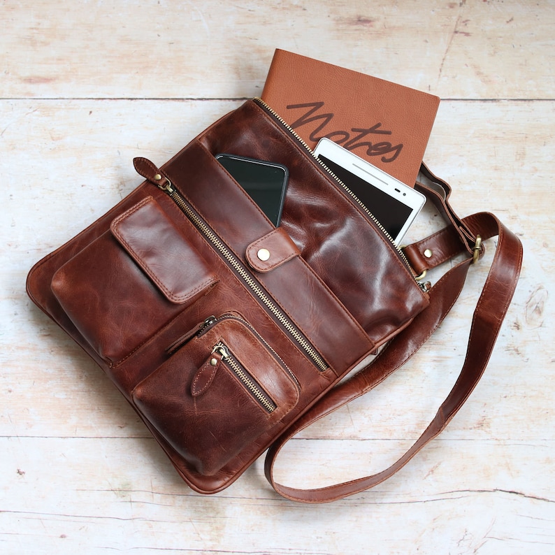 brown leather crossbody bag with front pockets and long adjustable shoulder strap