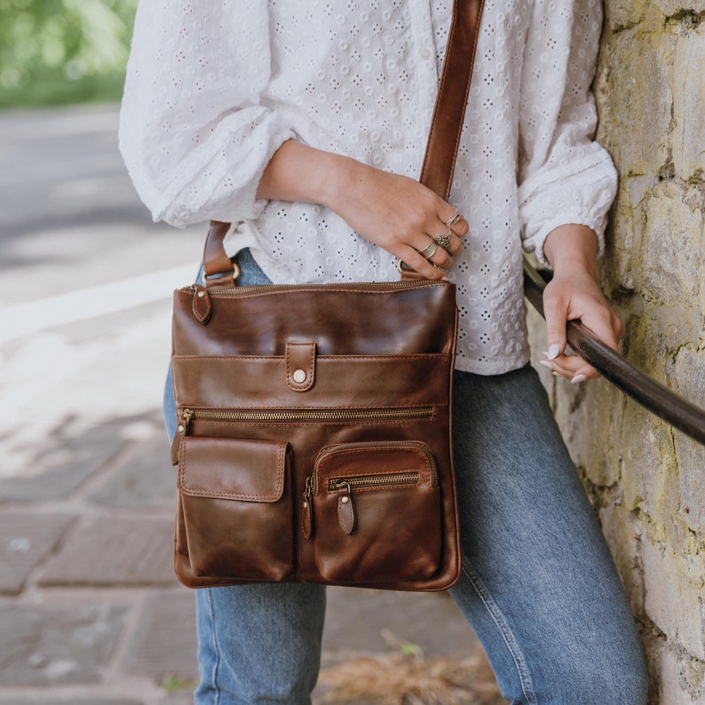 brown leather crossbody bag with long strap and front pockets