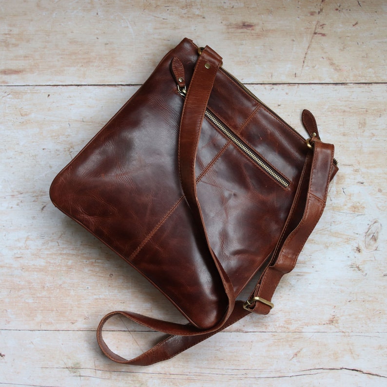 brown leather crossbody bag with zipped back pocket and long adjustable shoulder strap