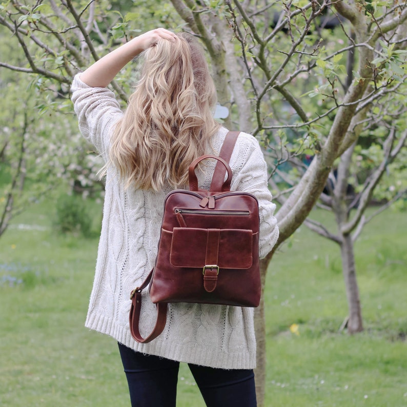 brown leather womens backpack with front pocket and adjustable shoulder straps