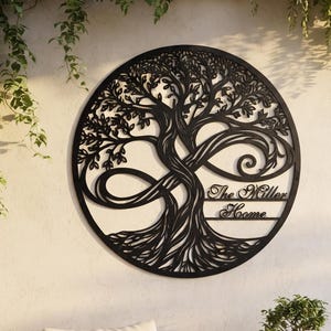 May include: A circular black metal wall art piece featuring an intricate tree of life design intertwined with an infinity symbol. The text The Miller Home is integrated into the right side of the tree trunk within the circular frame.
