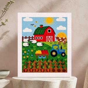 May include: A rectangular wall art piece featuring a textured punch needle farm scene. The design includes a red barn, a blue tractor, a brown and white cow, sheep, a yellow sun, clouds, and rows of orange carrots in a field with a wooden fence.
