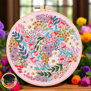 May include: An embroidered floral design on a pink fabric, set within a wooden hoop. The artwork showcases a variety of flowers, including roses and tulips, in shades of pink, red, white, and purple. The embroidery is detailed and colourful.